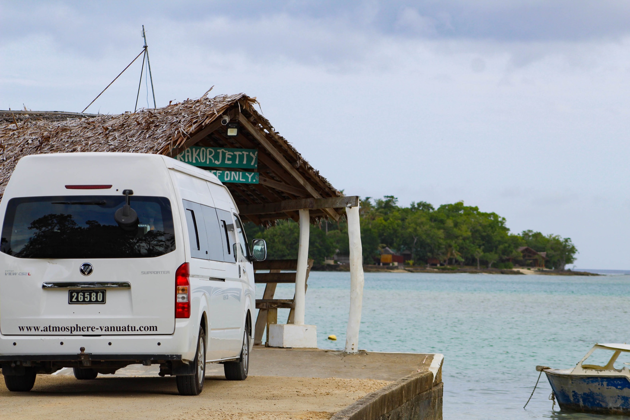 A small island jetty beside clear water.